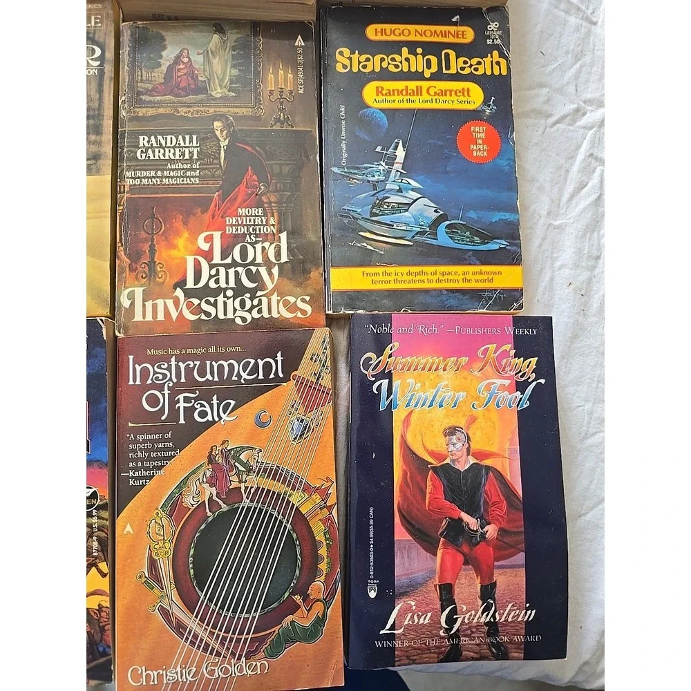 Lot of 9 Randall Garrett, Lisa Goldstein, Rick Cook & Christie Golden PB Books